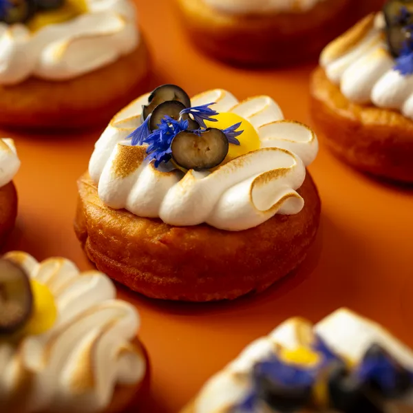 Cream desserts arranged carefully on a yellow surface