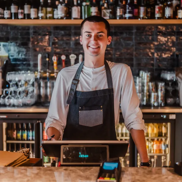 A male bartender smiling
