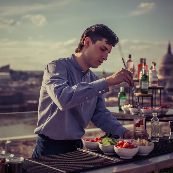 A bartender making a cocktail