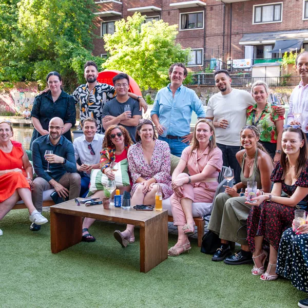 A team photo of people smiling outdoors